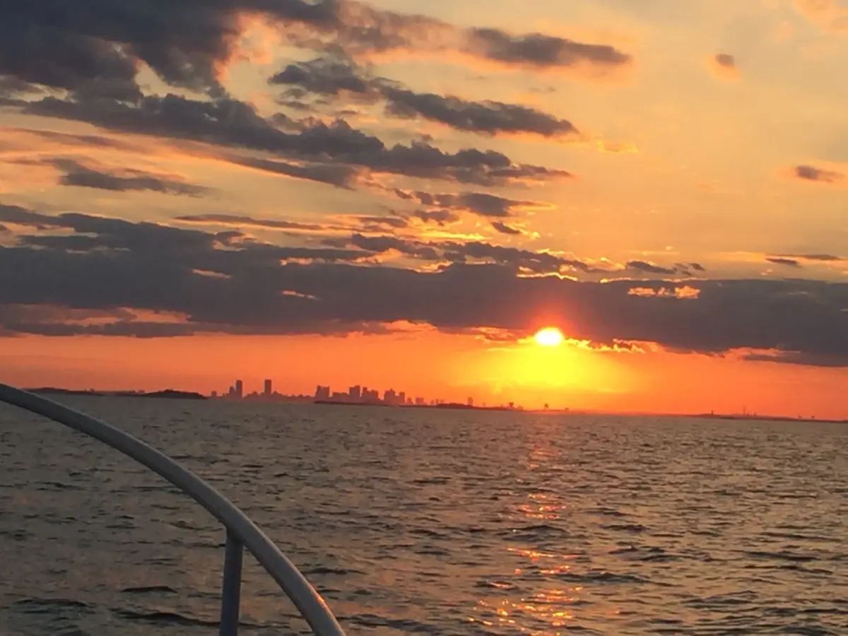 Sunset over Boston Harbor with the skyline on the horizon